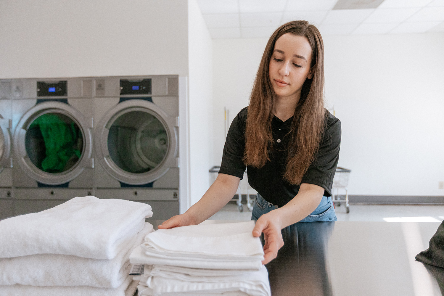 King Spin Laundry staff folding towels